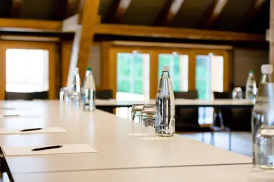a long table with glasses and a bottle on it at Hotel Krone Speicher in Speicher