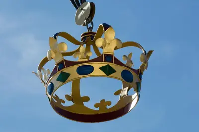 a gold crown hanging on a blue background at Hotel Krone Speicher in Speicher