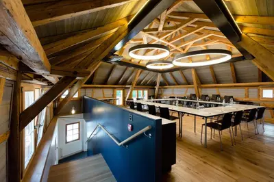 a dining room with a long table in a barn at Hotel Krone Speicher in Speicher