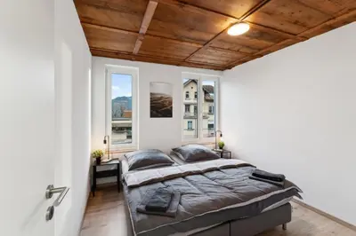 a bedroom with a large bed and two windows at FENUS SGT10 Panoramaview Parking Kitchen in Grabs