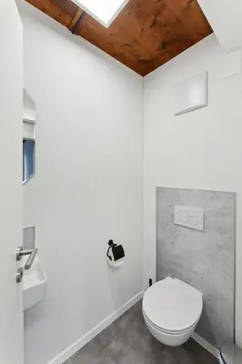 a bathroom with a white toilet and a sink at FENUS SGT10 Panoramaview Parking Kitchen in Grabs