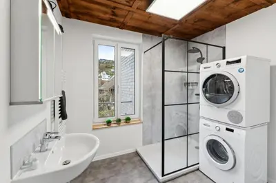 a bathroom with a sink and a washing machine at FENUS SGT10 Panoramaview Parking Kitchen in Grabs