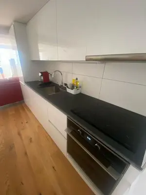 a kitchen with a black counter and a sink at Gemütliches Apartment am Schloss in Arbon