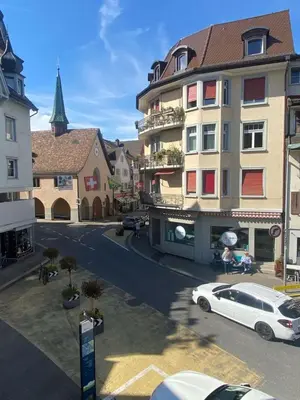 a white car parked in front of a building at Gemütliches Apartment am Schloss in Arbon