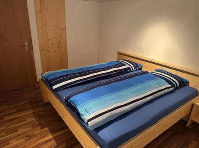 a bed with two pillows on top of it at Heimelige Wohnung auf der Schwägalp in Urnäsch