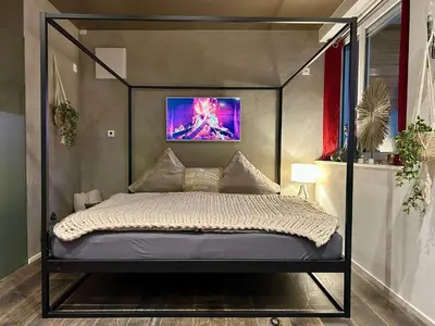 a black canopy bed in a room with at Private SPA Seeliebe - Ihre Ruheoase in Amriswil