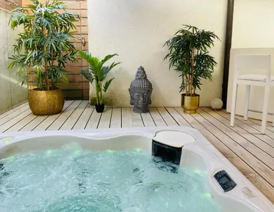 a jacuzzi tub in a patio with plants at Private SPA Seeliebe - Ihre Ruheoase in Amriswil
