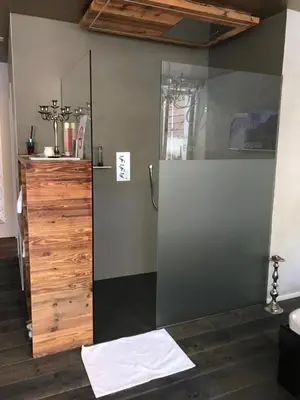 a bathroom with a shower with a glass door at Private SPA Seeliebe - Ihre Ruheoase in Amriswil
