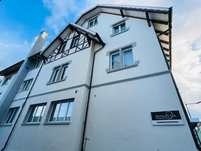 a white building with a sign on the side of it at Private SPA Seeliebe - Ihre Ruheoase in Amriswil