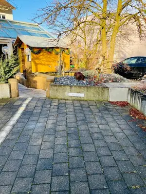 a cobblestone street in front of a yellow house at Private SPA Seeliebe - Ihre Ruheoase in Amriswil