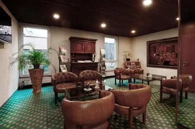 a waiting room with leather chairs and a salon at Hotel Thurgauerhof Self-Check-in in Weinfelden