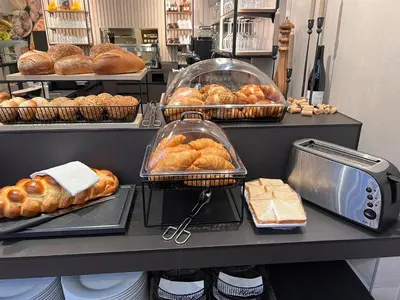 a bakery with bread and pastries on a counter at Hotel Thurgauerhof Self-Check-in in Weinfelden
