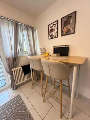 a dining room with a table with a laptop on it at Suite Executive Kreuzlingen - MTL Schweiz in Kreuzlingen