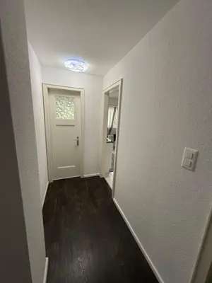an empty room with a hallway with a door at Suite Executive Kreuzlingen - MTL Schweiz in Kreuzlingen