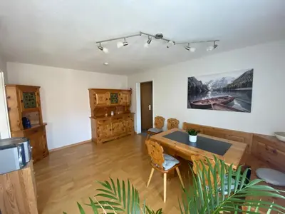 a living room with a wooden table and chairs at 3 Zimmer-Ferienwohnung in der Rüti in Herisau