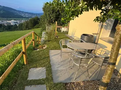 a table and chairs on a patio with a view at 3 Zimmer-Ferienwohnung in der Rüti in Herisau
