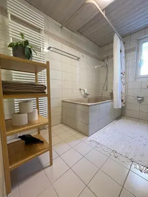 a bathroom with a tub and a sink at Charmante Ferienwohnung im Oberthurgau in Amriswil