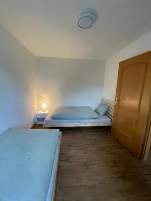 a small bedroom with two beds and a closet at Charmante Ferienwohnung im Oberthurgau in Amriswil