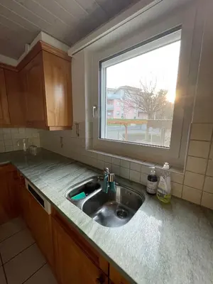 a kitchen with a sink and a window at Charmante Ferienwohnung im Oberthurgau in Amriswil