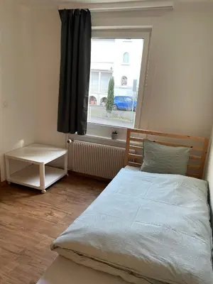 a bedroom with a large bed and a window at Charmante Ferienwohnung im Oberthurgau in Amriswil