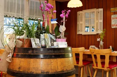 a dining room with a table with plants in a barrel at Haus Engel Gams in Gams