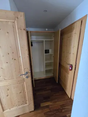 a room with two wooden doors and a closet at Haus Engel Gams in Gams