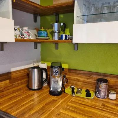 a kitchen counter with a blender on a wooden counter top at Auszeitoase am Wald und Bach in Kradolf