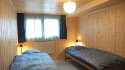 a bedroom with two beds and a window at Mällis Heimetli in Urnäsch
