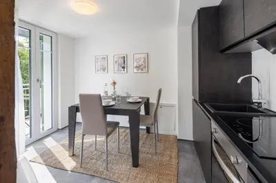 a dining room with a table and chairs in a kitchen at Klara 1034 - Olma, Spital, Uni St- Gallen in St. Gallen