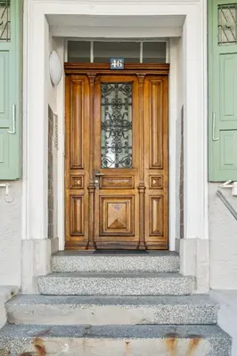 a wooden door on a house with stairs at Klara 1034 - Olma, Spital, Uni St- Gallen in St. Gallen