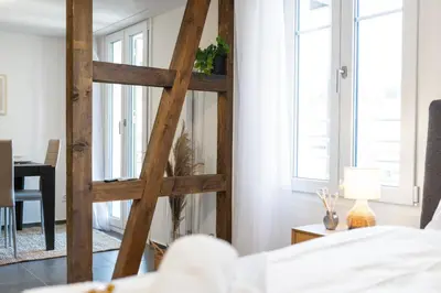 a room with a wooden ladder next to a bed at Klara 1033 - Olma, Spital, Uni St- Gallen in St. Gallen