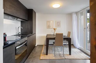 a kitchen and dining room with a table and a window at Klara 1033 - Olma, Spital, Uni St- Gallen in St. Gallen