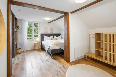 a bedroom with a bed and a large window at Klara 1033 - Olma, Spital, Uni St- Gallen in St. Gallen
