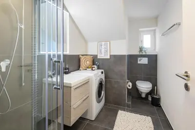 a bathroom with a sink and a washing machine at Klara 1033 - Olma, Spital, Uni St- Gallen in St. Gallen