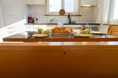 a kitchen with a table with plates of food on it at Eldanora in Wildhaus