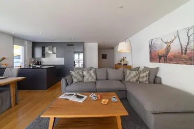 a living room with a couch and a table at Saentis in Wildhaus