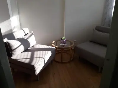 a small room with a bed and a table and a chair at Hotel Garni Frohsinn in Uttwil