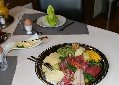 a plate of food on top of a table at Hotel Garni Frohsinn in Uttwil