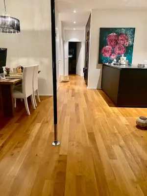 a living room with a wooden floor and a baseball bat at Mountain View luxury up to four persons in Diepoldsau