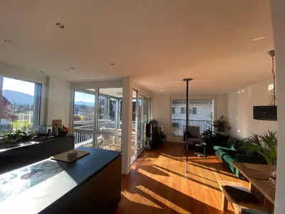 a living room with a couch and a table at Mountain View luxury up to four persons in Diepoldsau