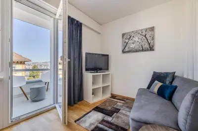 a bedroom with a bed and a mirror at Ferienwohnung mit Balkon W7 in St. Gallen