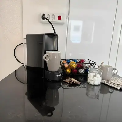 a coffee maker on a counter with a basket of muffins at Gemütliche und geräumige 2,5 Zimmer Wohnung mit kostenlosem Parkplatz in St. Gallen