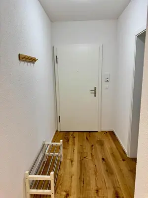 an empty room with a bed and a door at Gemütliche und geräumige 2,5 Zimmer Wohnung mit kostenlosem Parkplatz in St. Gallen