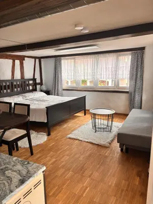 a bedroom with two beds and a table at Im Herzen von Rebstein in Rebstein