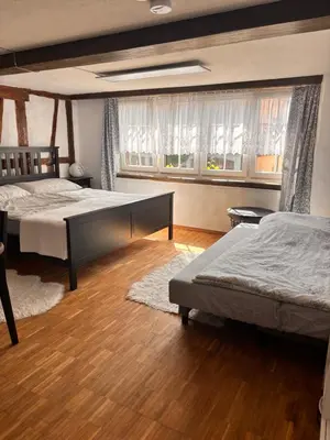 a bedroom with two beds and a window at Im Herzen von Rebstein in Rebstein