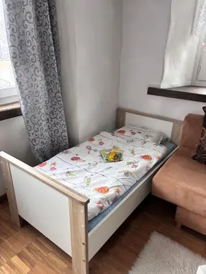 a small bed in a room next to a window at Im Herzen von Rebstein in Rebstein
