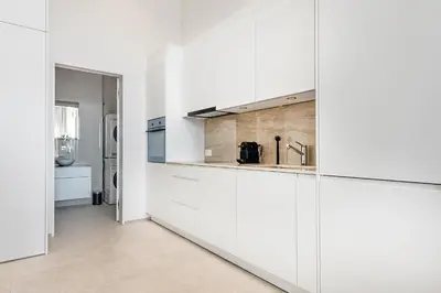 a kitchen with white cabinets and a sink at DESIGN-STUDIO 3 !Gratis Parken, Free Parking! in Kreuzlingen