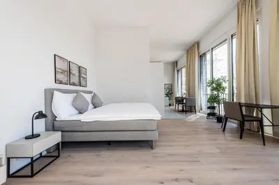 a bedroom with a bed and a table and chairs at DESIGN-STUDIO 4 !Gratis Parken, Free Parking! in Kreuzlingen