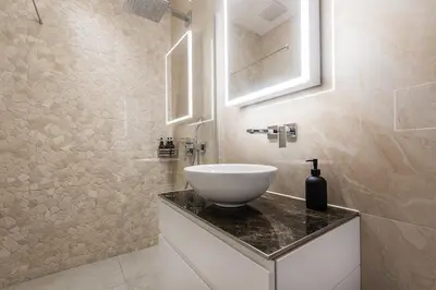 a bathroom with a white bowl sink on a counter at DESIGN-STUDIO 2 !Gratis Parken, Free Parking! in Kreuzlingen