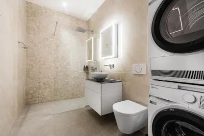 a bathroom with a sink and a washing machine at DESIGN-STUDIO 2 !Gratis Parken, Free Parking! in Kreuzlingen